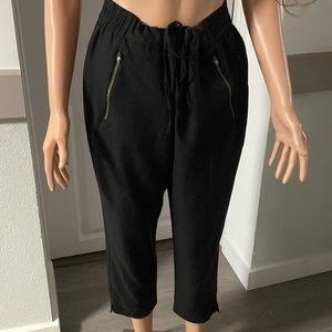 Black pants pulled in the belt